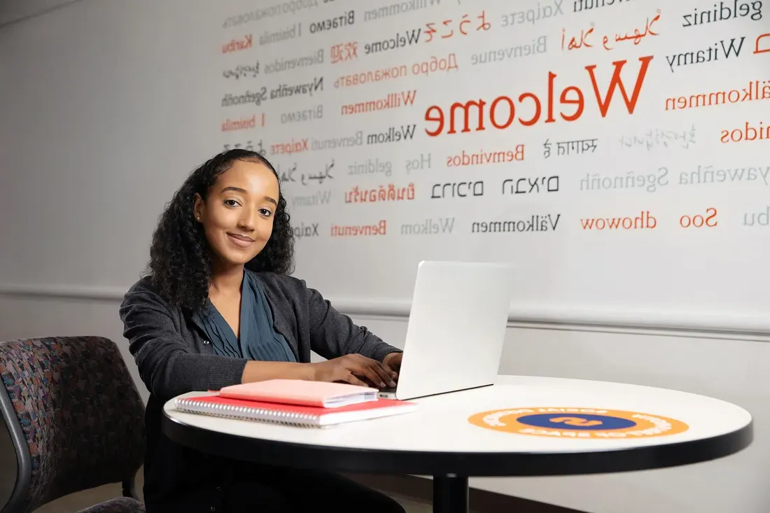 Student sitting and working on computer.